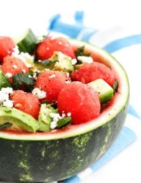 Watermelon salad with cucumber, avocado, feta, and mint served in the watermelon rind