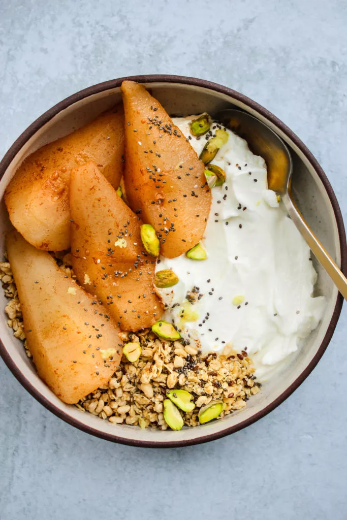 ginger, cinnamon, and honey-poached pears over greek yogurt, granola bowl