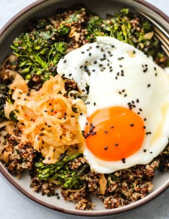 quinoa, kimchi, broccolini, and egg in bowl