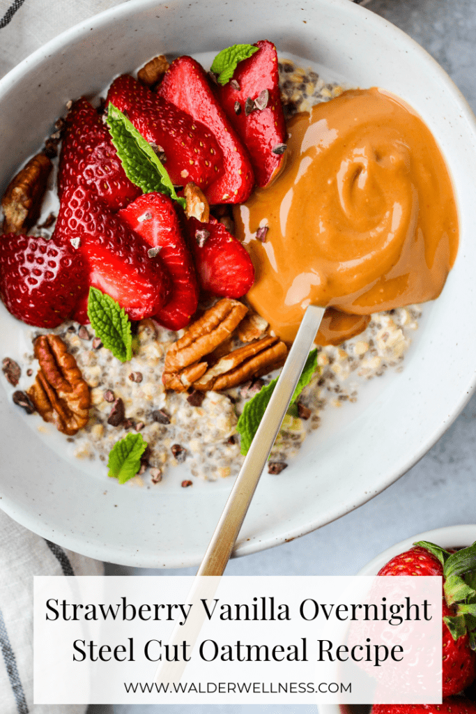 overnight steel cut oatmeal topped with strawberry slices, mint leaves, pecans, and peanut butter