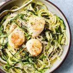 pan seared scallops and zucchini noodle pasta in a white and brown bowl