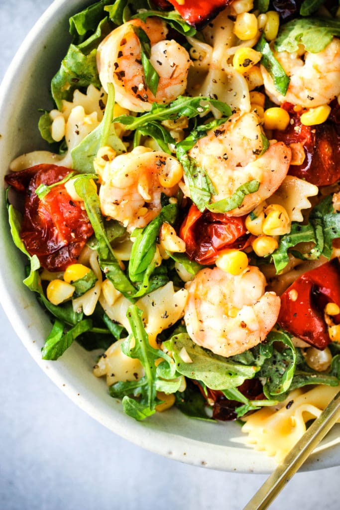 roasted vegetable pasta salad with red peppers, corn, tomatoes, arugula, shrimp