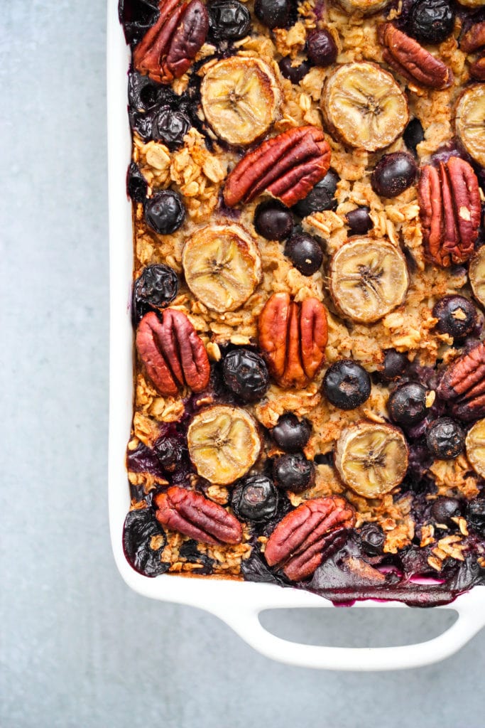 blueberry banana baked oatmeal with pecans in white baking dish