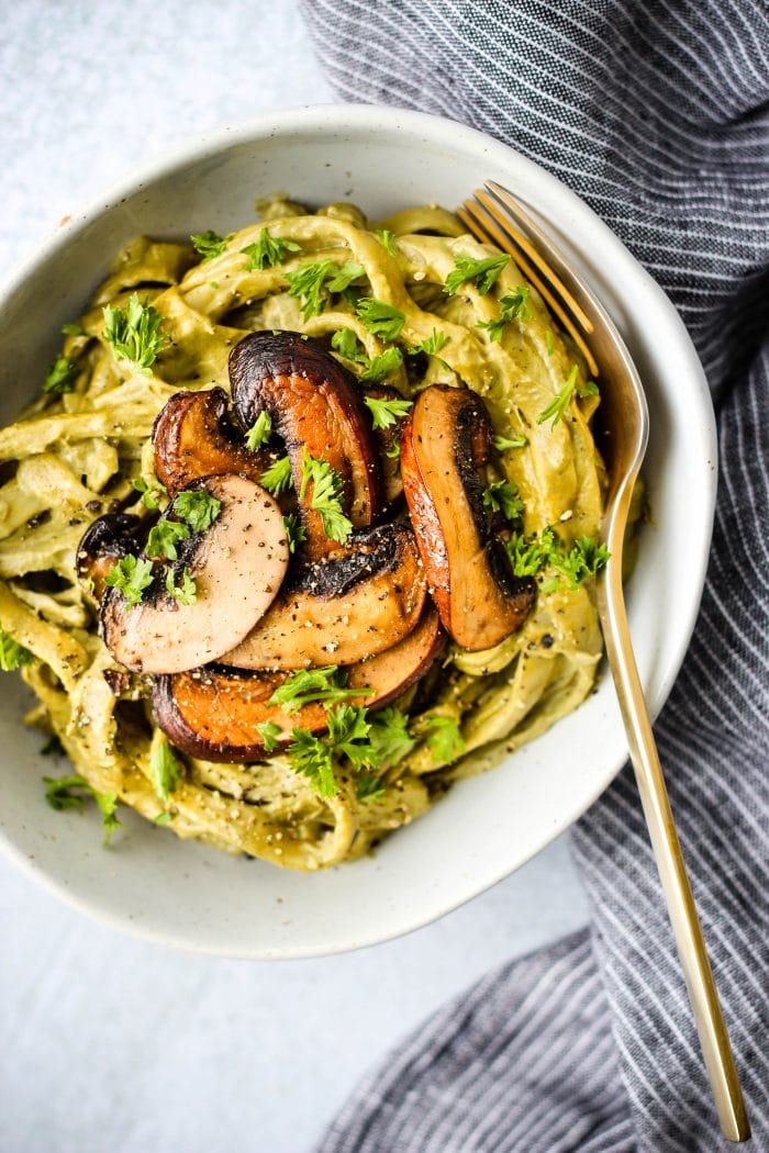 mushroom cashew cream pasta topped with mushrooms in a bowl