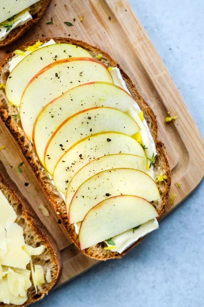 slice of bread topped with cheese and apple slices