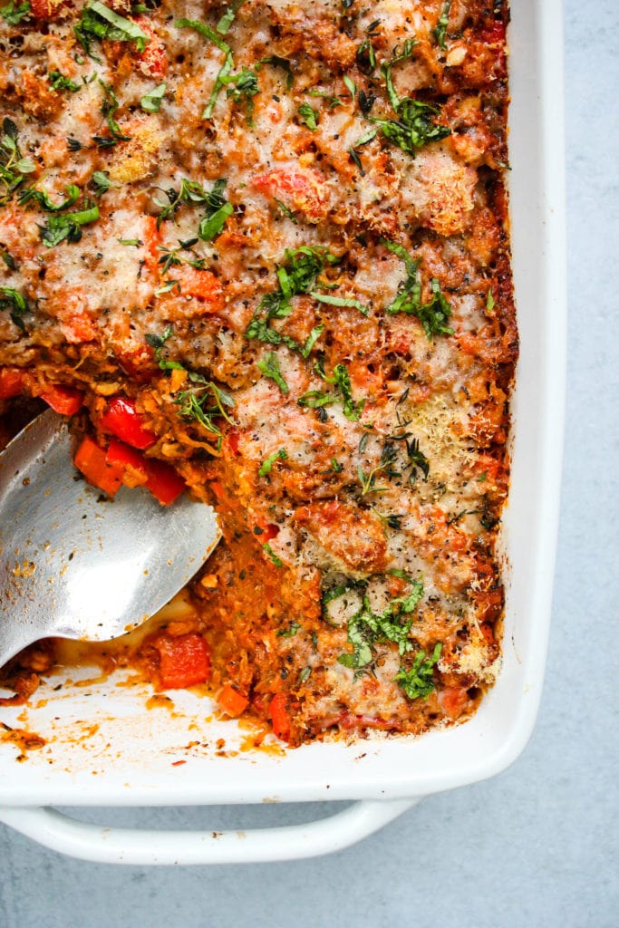 baked spaghetti squash casserole with tempeh bolognese in white baking dish