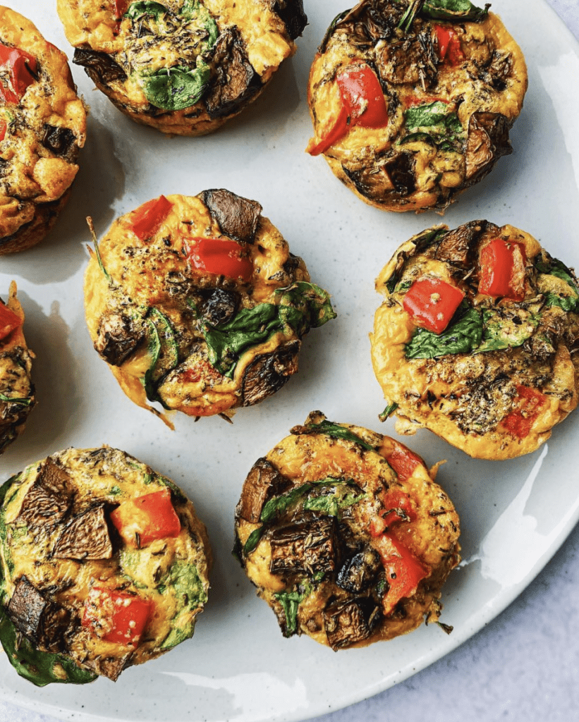 breakfast egg muffins with mushrooms, peppers, spinach, and gruyere cheese