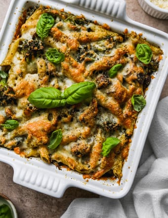 Baked penne pesto pasta in a baking dish.