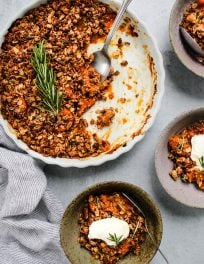 rosemary apricot crisp in white baking dish and three small serving bowls