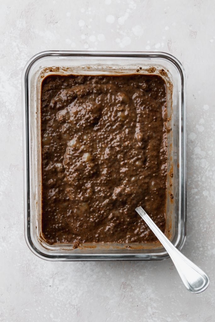 overhead photo of chocolate banana chia seed pudding in a rectangular glass continer