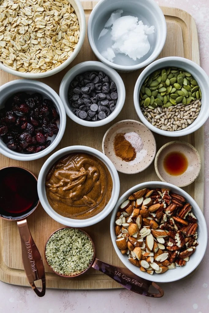 Overhead photo of white bowls of ingredients on top of a wood cutting board.