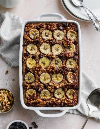 Overhead photo of a white baking dish filled with a peanut butter banana baked oatmeal.