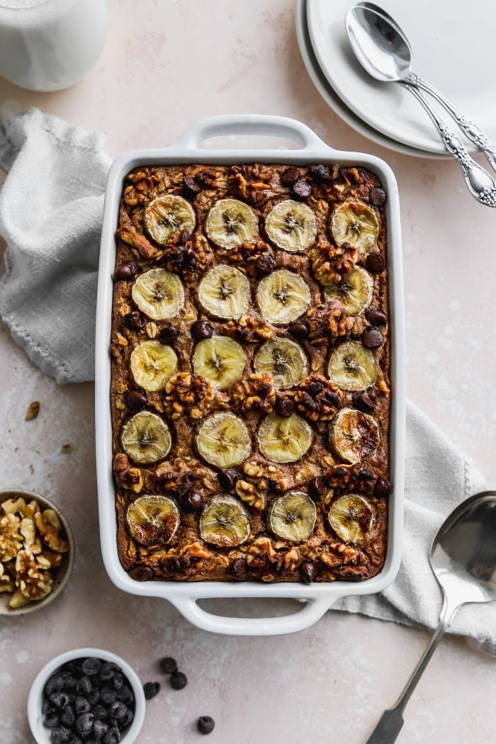Overhead photo of a white baking dish filled with a peanut butter banana baked oatmeal.