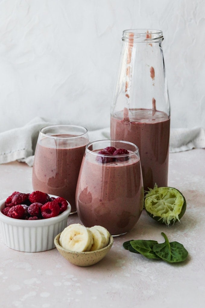 Straight on photo of a raspberry banana smoothie in glass cups.