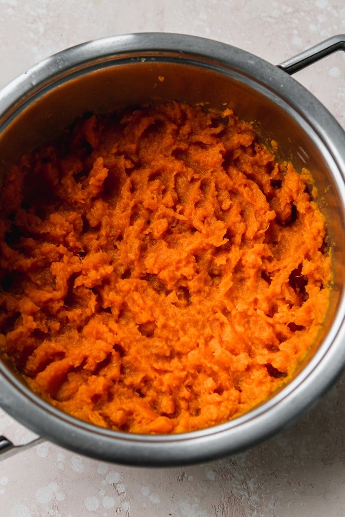 Overhead photo of mashed sweet potatoes in a large pot.