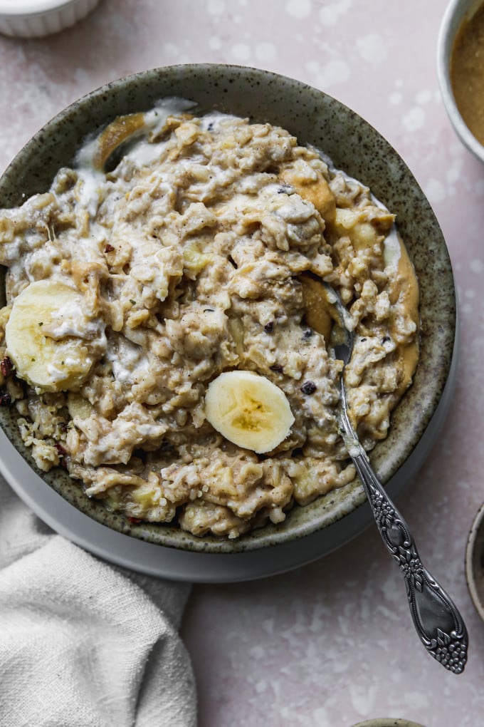 Closeup photo of a banana tahini oatmeal porridge stirred together.