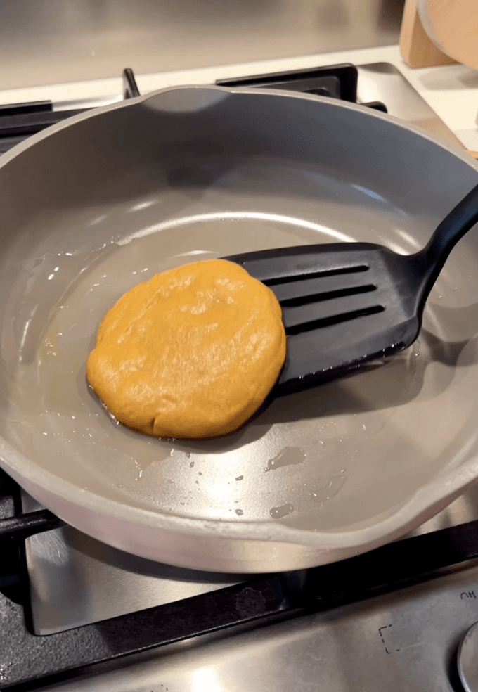 Flipping pancake over in a pan.