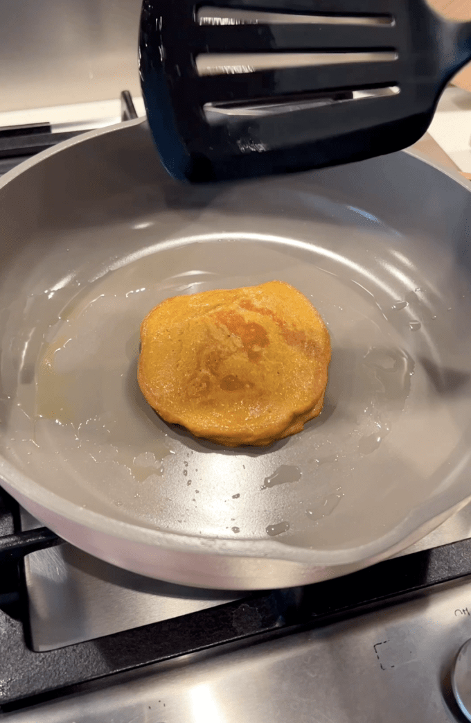 Cooked butternut squash pancake in a pan.