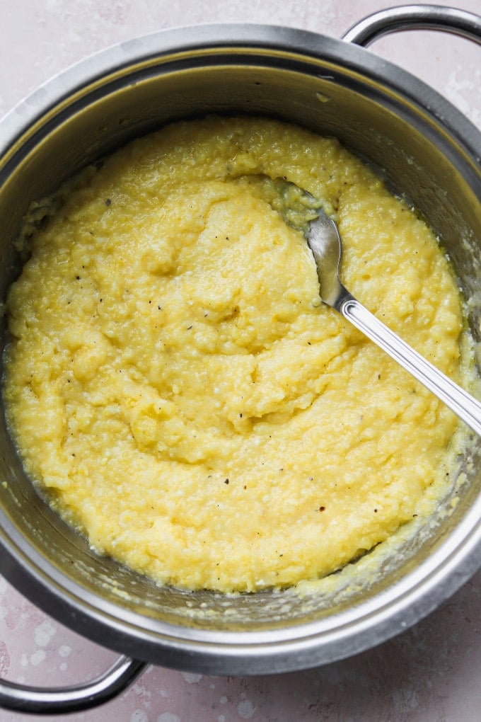 Creamy parmesan polenta in a large sauce pan.