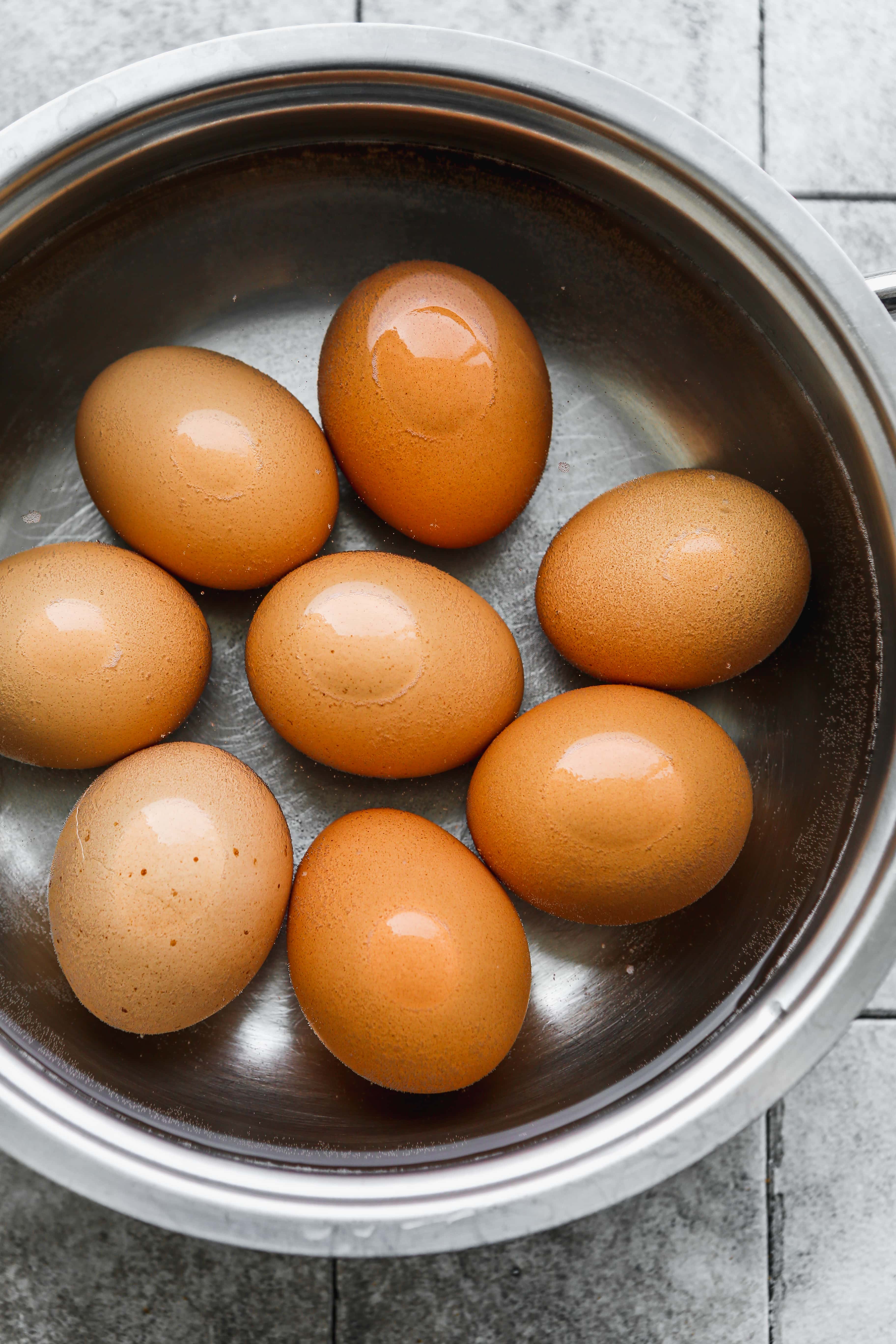 Hard-boiled eggs in a pot with water.