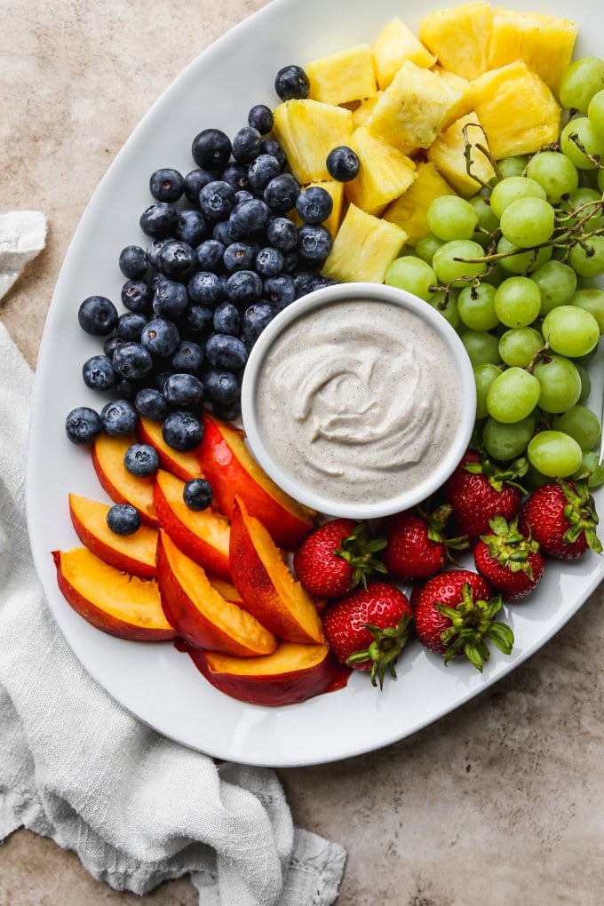 Fruit platter with a bowl of yogurt fruit dip.