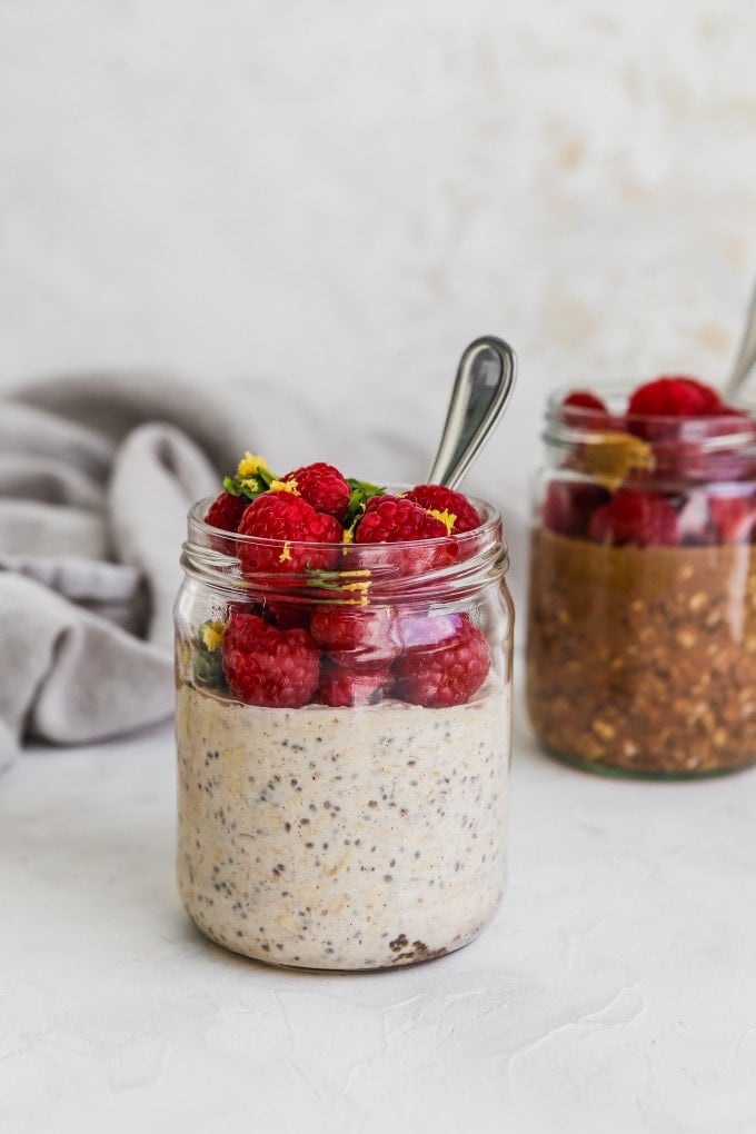 Two types of raspberry overnight oats in jars.