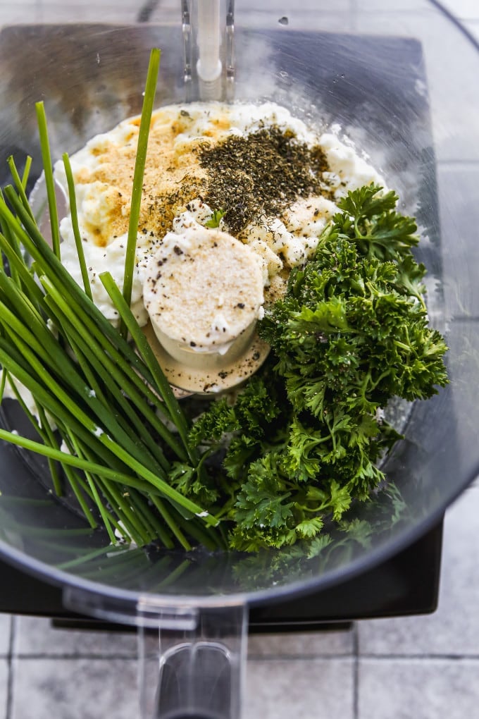 Chives, parsley, cottage cheese, and spices in a food processor.