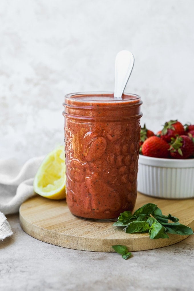 Strawberry balsamic vinaigrette in a glass jar.