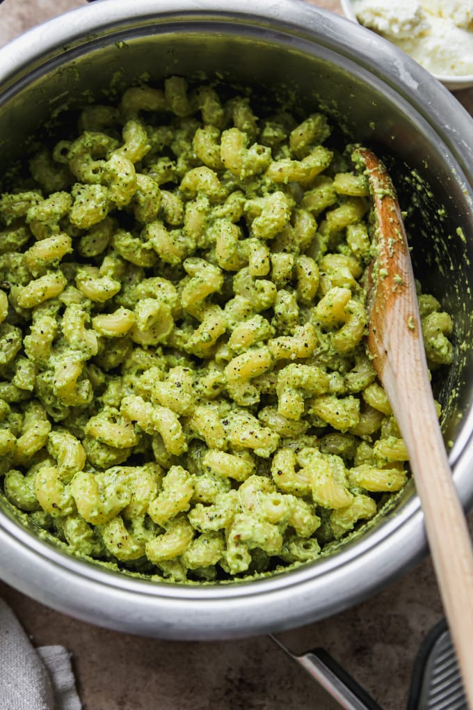 A large pot of pasta tossed in ricotta pesto.