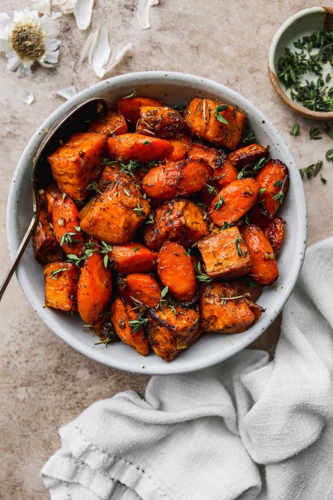 Roasted sweet potatoes and carrots in a serving bowl.