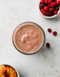 Cranberry smoothie in a glass jar.