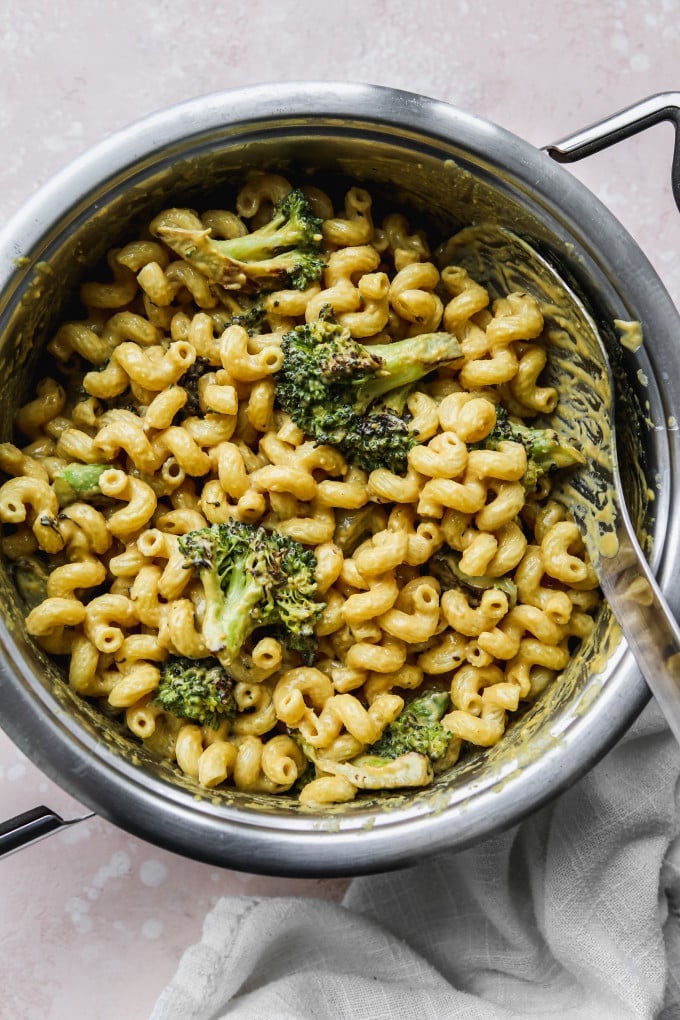 Pasta tossed with tahini sauce and broccoli in a large pot.