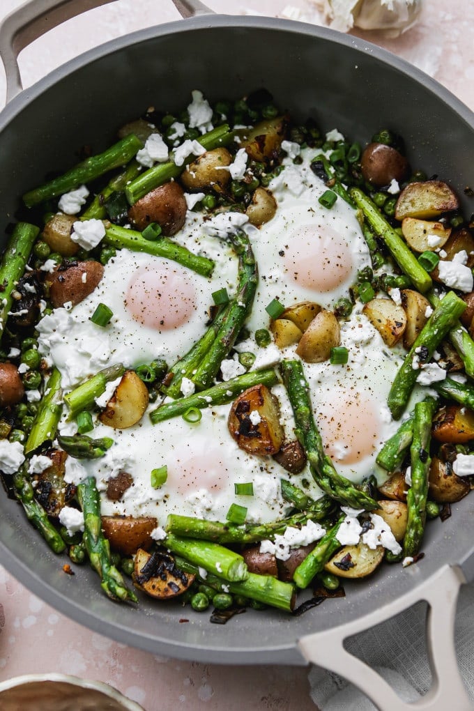 Asparagus and eggs breakfast skillet in a large pan.