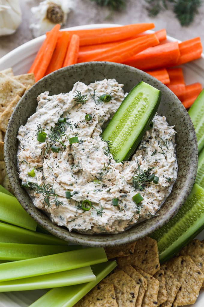 Cucumber dipped into canned salmon dip.
