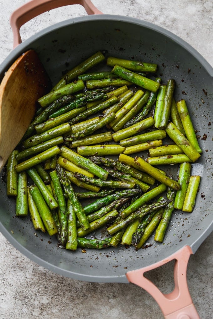 Asparagus pan-fried in a large skillet.