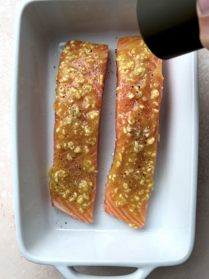 Honey, dijon, and garlic spread over top of two salmon fillets.