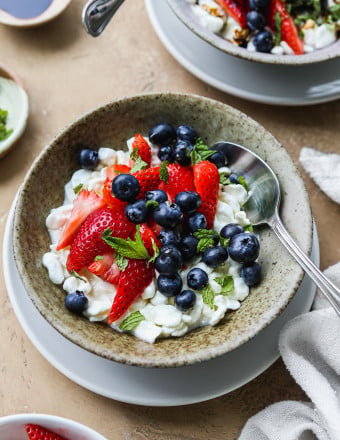 Cottage cheese topped with fruit, mint, and honey.