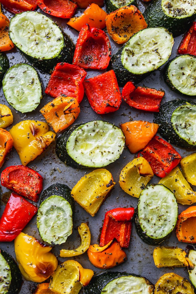 Roasted peppers and zucchini on a sheet pan.