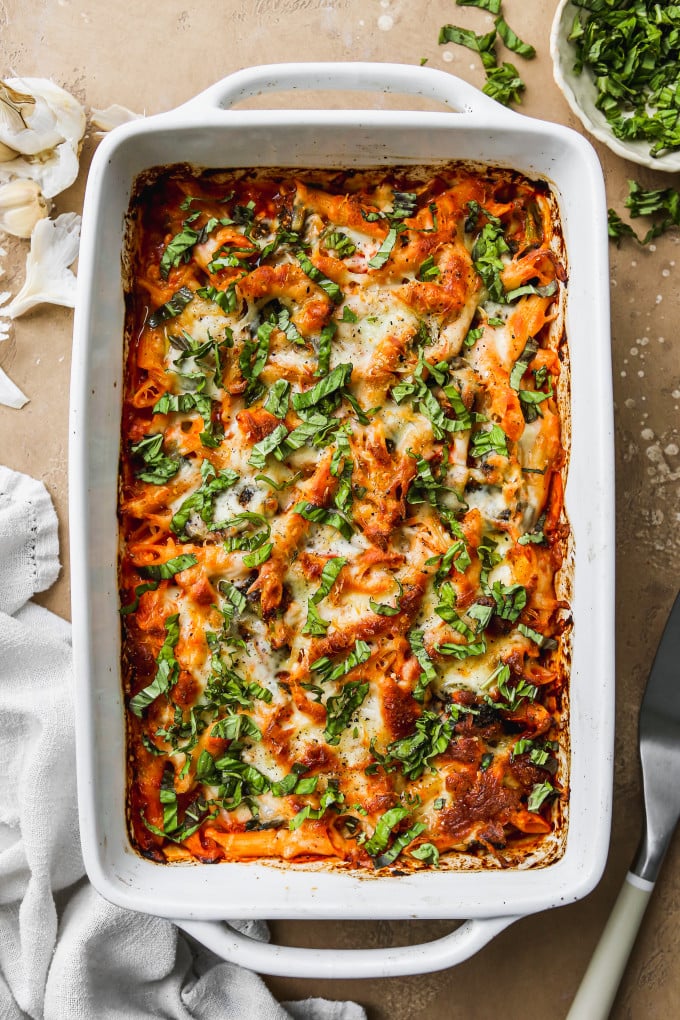 Cottage cheese pasta bake in baking dish, topped with chopped basil.