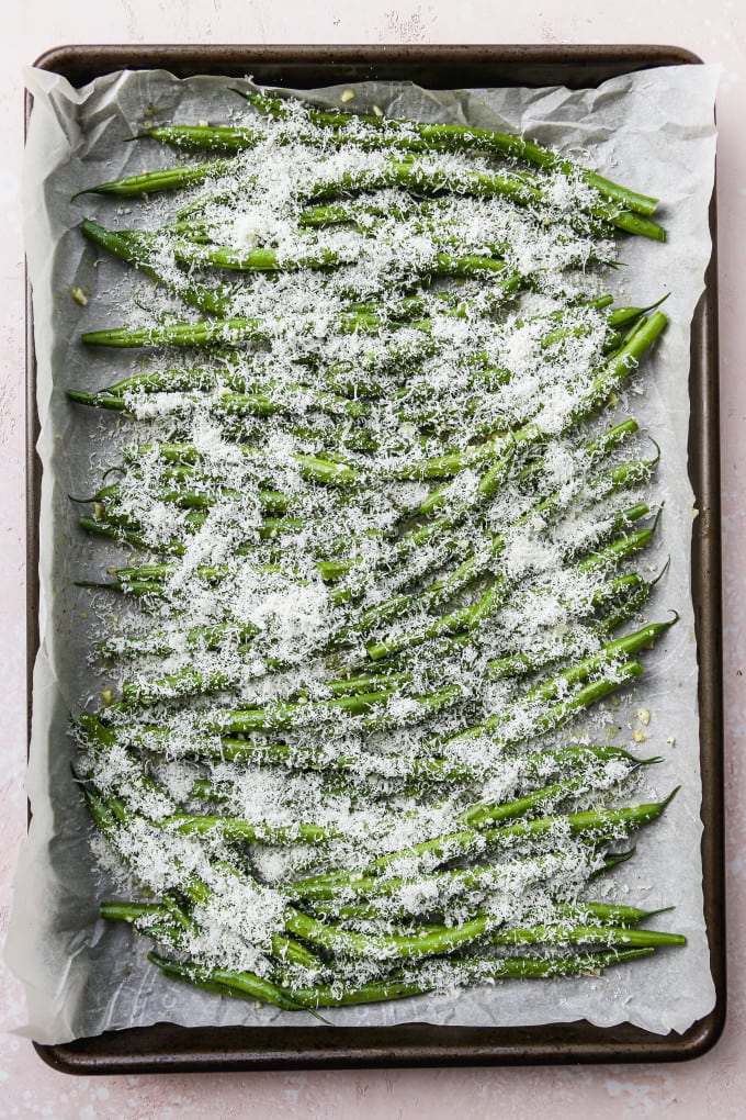 Green beans on pan topped with grated parmesan.