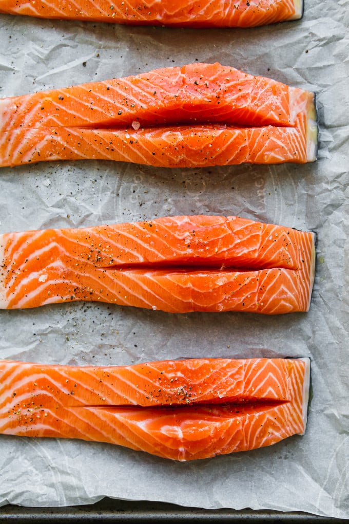 Four pieces of salmon, cut down the middle.
