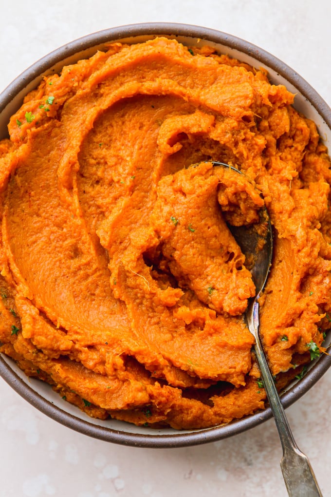 Savory mashed sweet potatoes in a serving bowl.