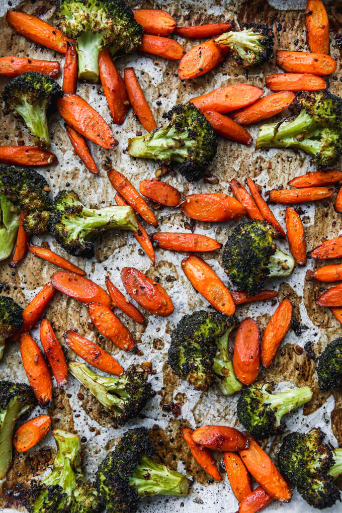 Roasted broccoli and carrots on a baking sheet.