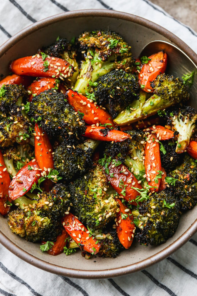 Asian roasted broccoli and carrots in a serving bowl.