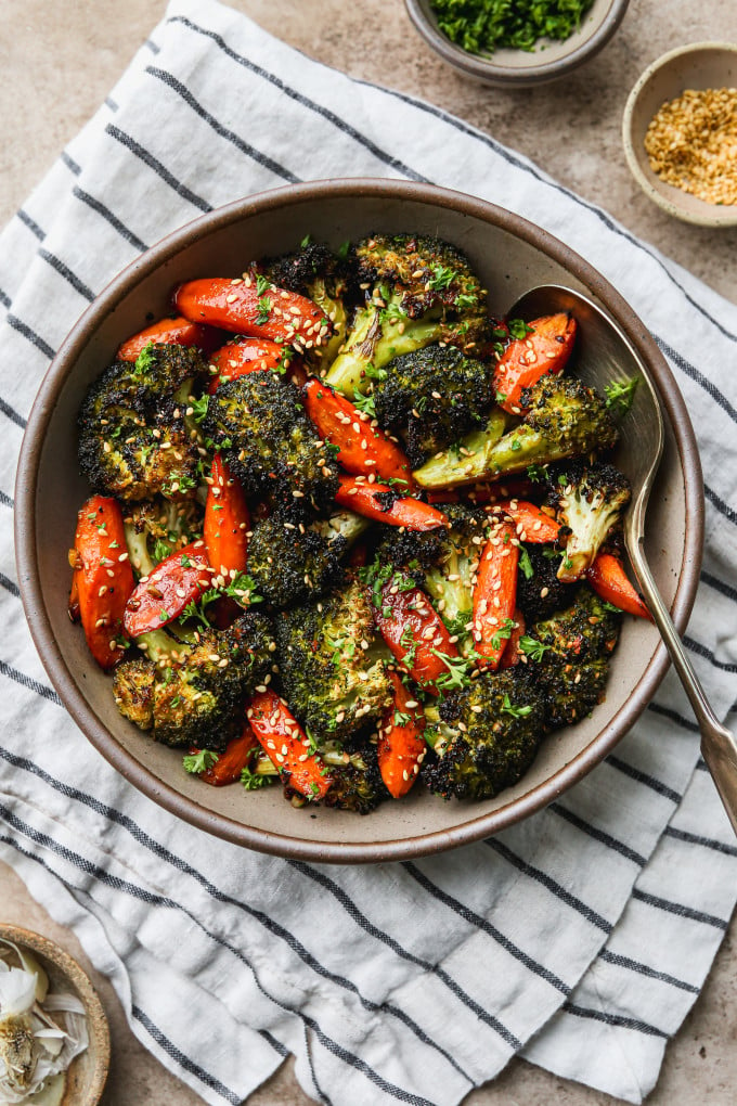 Roasted broccoli and carrots in a serving bowl.