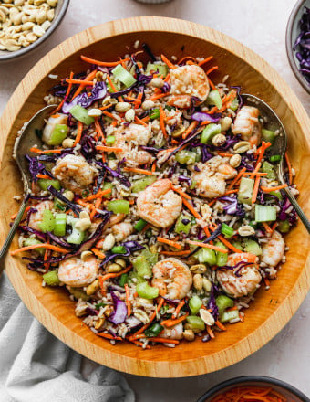 Asian shrimp rice salad tossed in salad bowl.